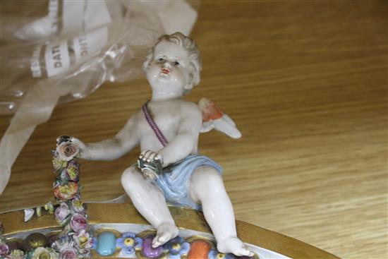 A Meissen porcelain dressing table mirror, surmounted with cherubs (a.f.), overall height 56cm